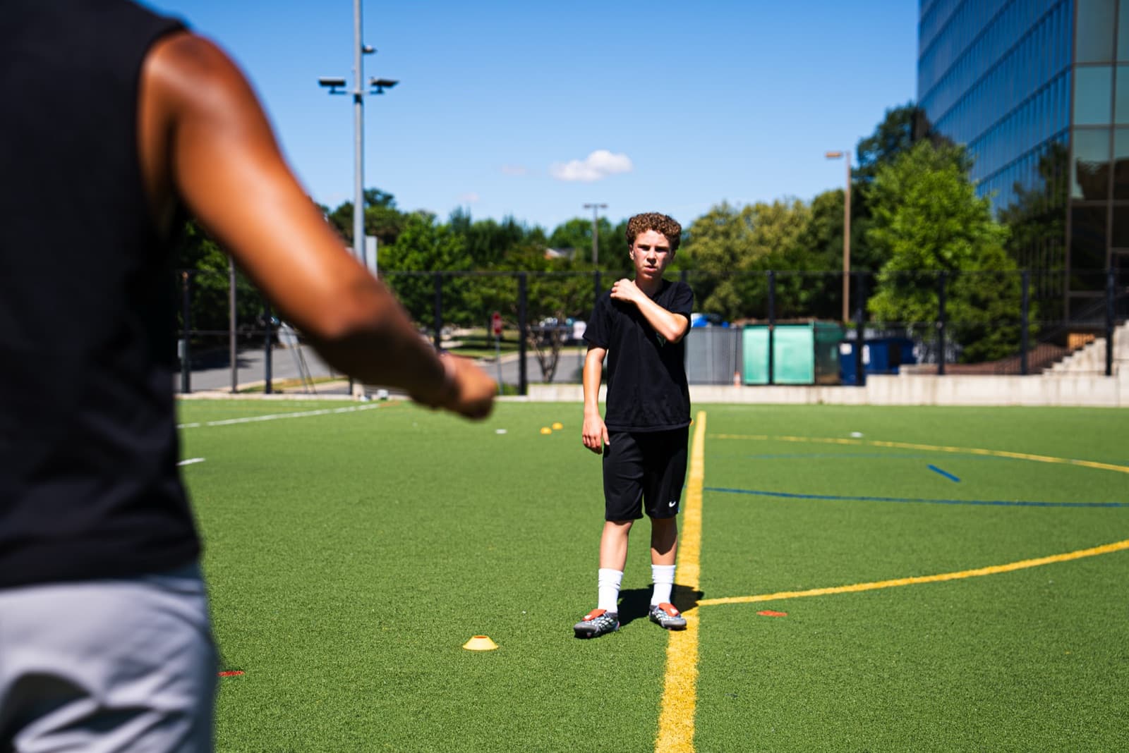 Coach and player working a passing pattern on Northern Virginia turf